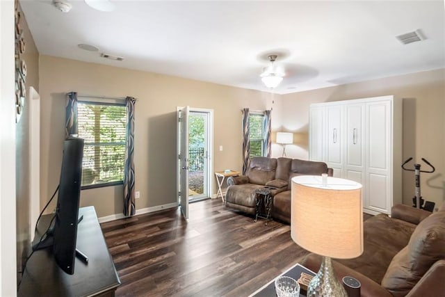 living room featuring dark hardwood / wood-style floors and ceiling fan