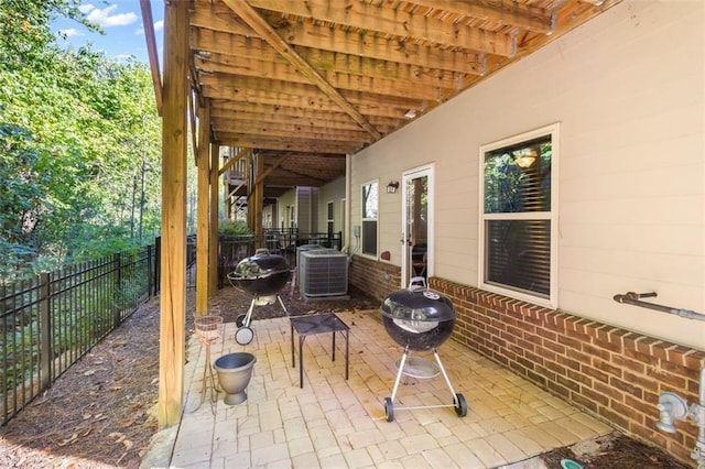 view of patio / terrace featuring central air condition unit, area for grilling, and an outdoor fire pit