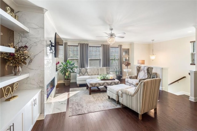 living room featuring dark hardwood / wood-style flooring, ceiling fan, ornamental molding, and a premium fireplace