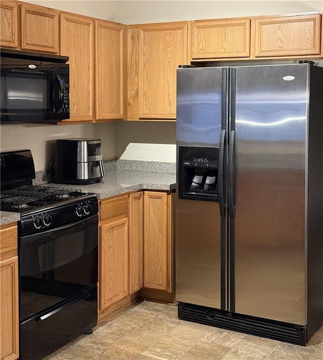 kitchen featuring black appliances and light countertops