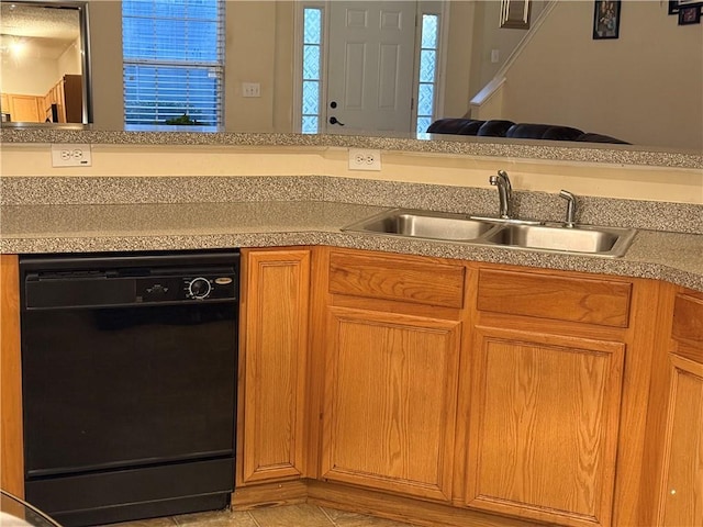 kitchen featuring brown cabinetry, dishwasher, light countertops, light tile patterned flooring, and a sink