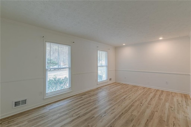7020 Camp Valley Rd, Riverdale, GA 30296 - spare room with visible vents, crown molding, baseboards, a textured ceiling, and light wood-style flooring