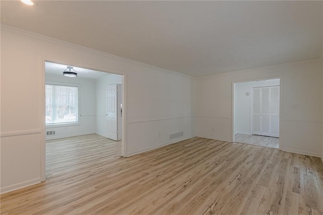 7020 Camp Valley Rd, Riverdale, GA 30296 - empty room featuring crown molding, baseboards, light wood finished floors, and visible vents