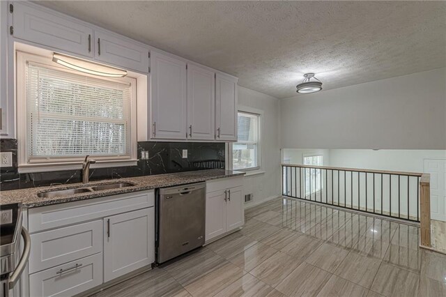 7020 Camp Valley Rd, Riverdale, GA 30296 - kitchen featuring a sink, a textured ceiling, white cabinets, and stainless steel appliances
