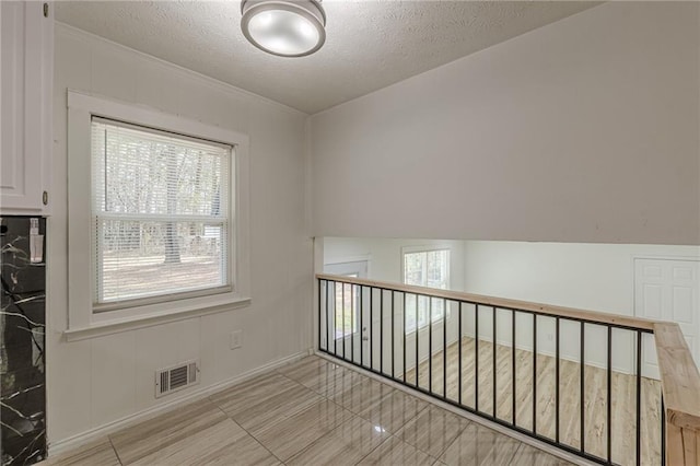7020 Camp Valley Rd, Riverdale, GA 30296 - spare room with a textured ceiling, visible vents, plenty of natural light, and baseboards