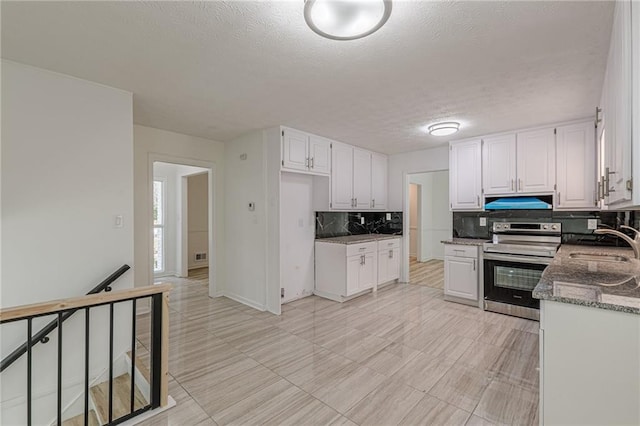 7020 Camp Valley Rd, Riverdale, GA 30296 - kitchen featuring stainless steel range with electric cooktop, a sink, white cabinetry, decorative backsplash, and under cabinet range hood