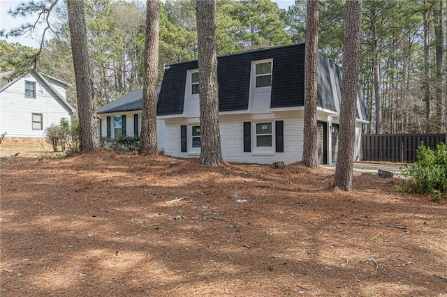 7020 Camp Valley Rd, Riverdale, GA 30296 - view of front of property with brick siding, mansard roof, fence, an attached garage, and a shingled roof