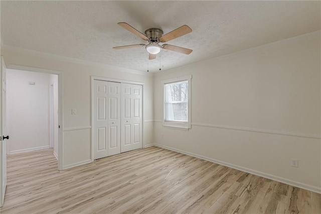 7020 Camp Valley Rd, Riverdale, GA 30296 - unfurnished bedroom with a closet, a textured ceiling, ornamental molding, and light wood-type flooring