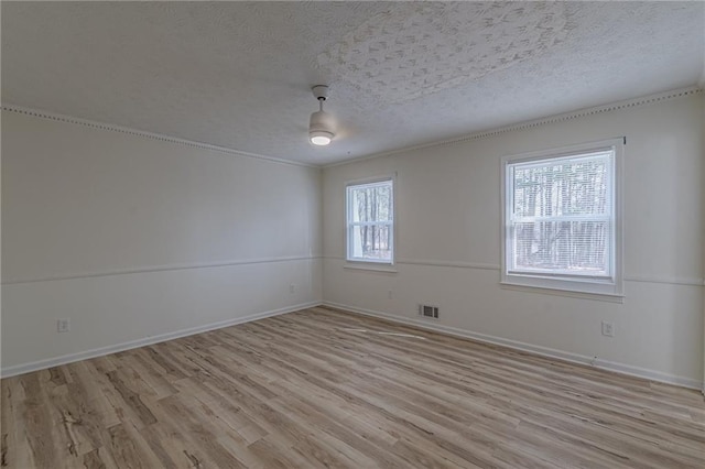7020 Camp Valley Rd, Riverdale, GA 30296 - spare room featuring baseboards, light wood finished floors, a textured ceiling, and visible vents