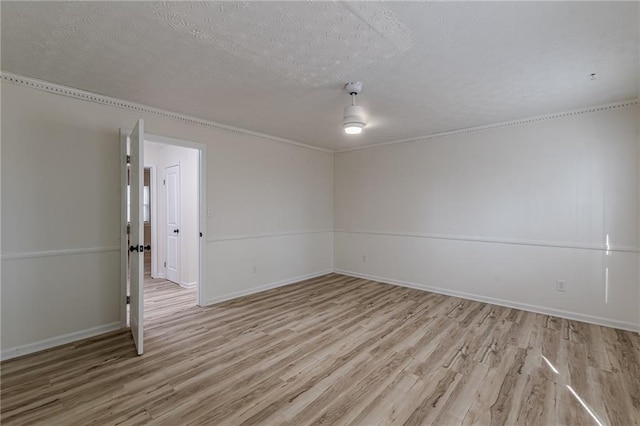 7020 Camp Valley Rd, Riverdale, GA 30296 - empty room featuring baseboards, light wood-type flooring, and a textured ceiling
