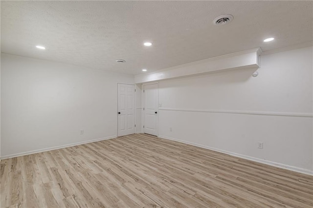 7020 Camp Valley Rd, Riverdale, GA 30296 - finished basement with a textured ceiling, recessed lighting, baseboards, light wood-type flooring, and visible vents