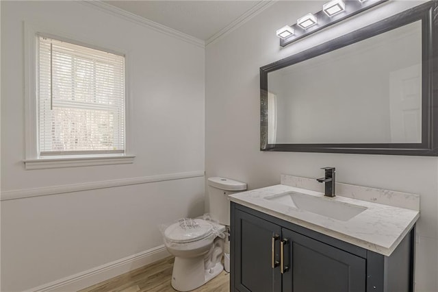 7020 Camp Valley Rd, Riverdale, GA 30296 - half bathroom featuring crown molding, vanity, toilet, baseboards, and wood finished floors