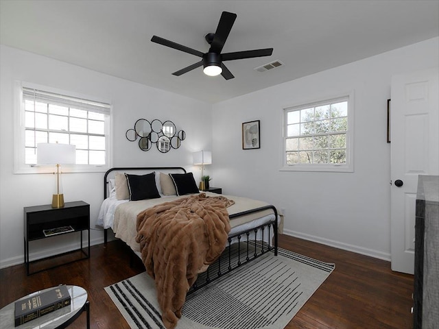 bedroom with dark hardwood / wood-style floors and ceiling fan