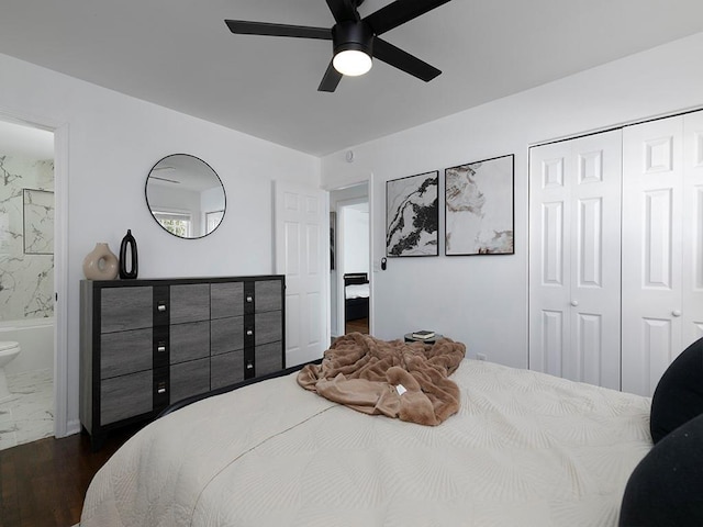 bedroom featuring dark wood-type flooring, ceiling fan, connected bathroom, and a closet