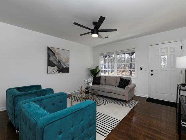 living room featuring dark hardwood / wood-style floors and ceiling fan