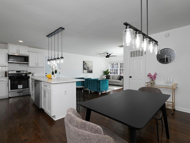 dining room featuring ceiling fan and dark hardwood / wood-style floors