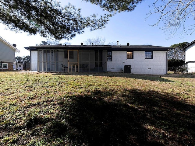 rear view of house with a sunroom, a lawn, and central air condition unit