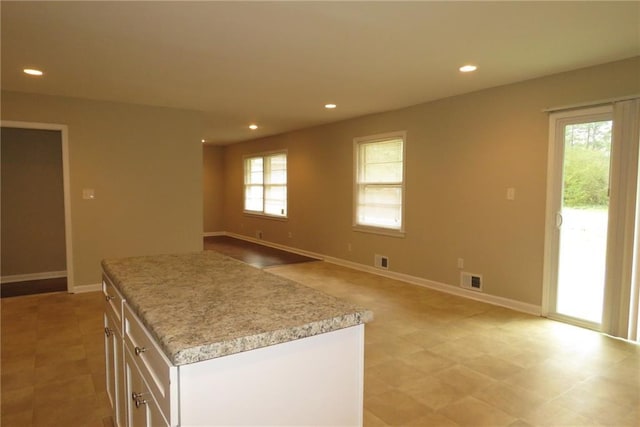 kitchen featuring recessed lighting, white cabinets, light countertops, and visible vents