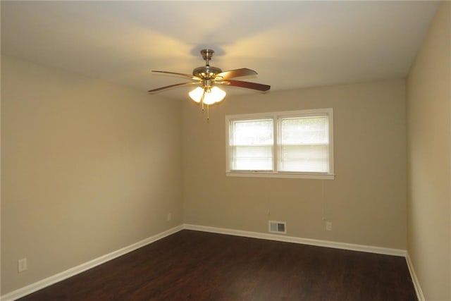 empty room with a ceiling fan, baseboards, visible vents, and dark wood-style flooring