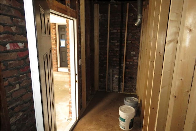 hallway featuring brick wall