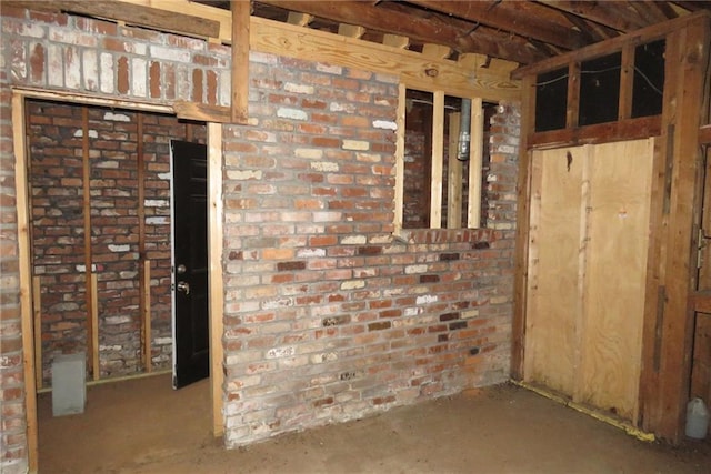 interior space featuring brick wall