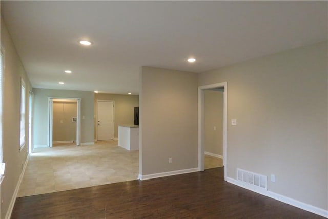 spare room featuring recessed lighting, visible vents, baseboards, and light wood-style floors