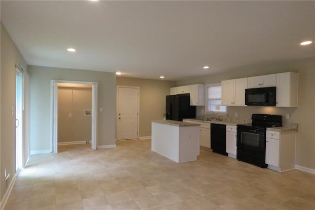 kitchen with baseboards, recessed lighting, black appliances, white cabinetry, and a center island