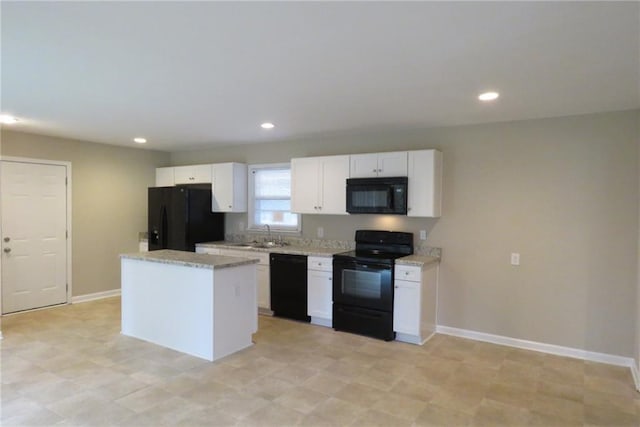 kitchen with baseboards, a kitchen island, black appliances, and white cabinetry