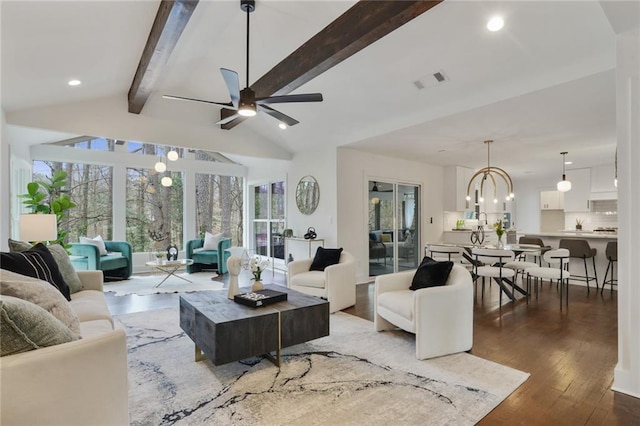 living room with vaulted ceiling with beams, recessed lighting, visible vents, hardwood / wood-style floors, and ceiling fan with notable chandelier