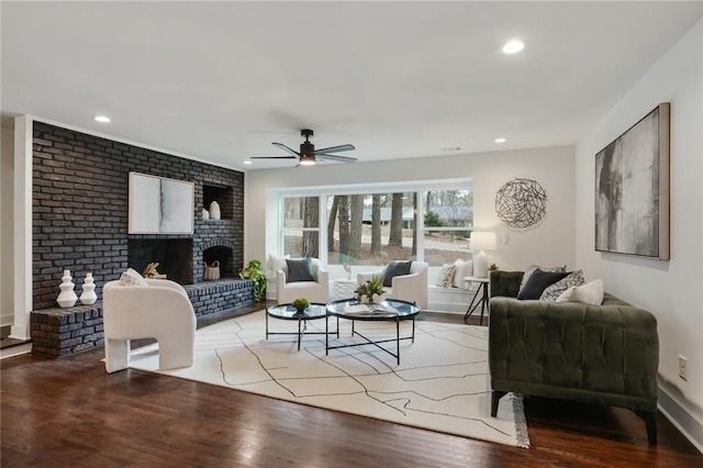 living room with recessed lighting, a brick fireplace, ceiling fan, wood finished floors, and baseboards