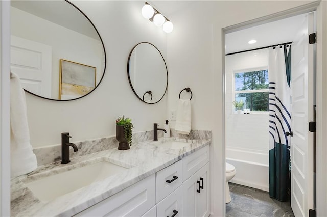 full bathroom with double vanity, shower / bath combo, toilet, and a sink