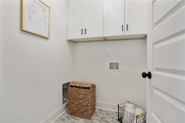 laundry room featuring washer hookup, cabinet space, and baseboards