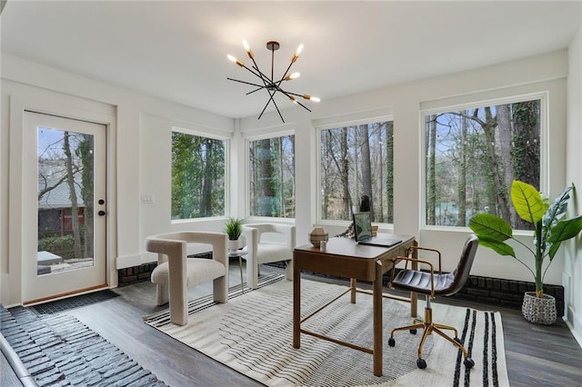 sunroom / solarium featuring a chandelier and a healthy amount of sunlight