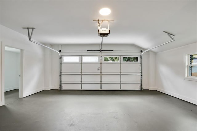 garage with a garage door opener and baseboards