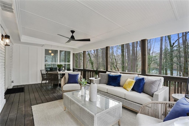 sunroom featuring visible vents and ceiling fan