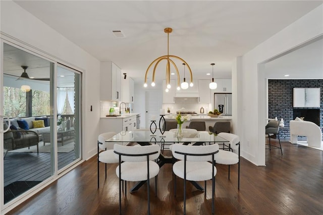 dining space featuring a chandelier, dark wood-type flooring, and visible vents