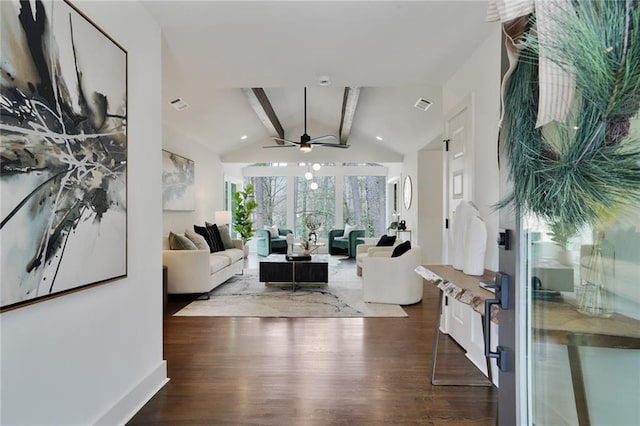 living area with vaulted ceiling with beams, wood finished floors, and visible vents