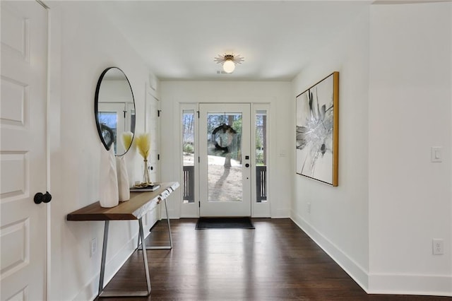 entryway featuring baseboards and dark wood-style flooring