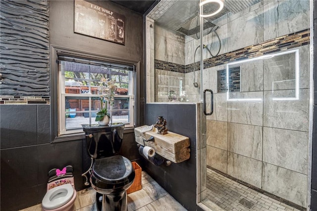 bathroom featuring toilet, walk in shower, and tile walls