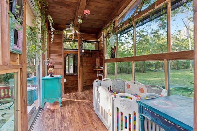 sunroom / solarium featuring wooden ceiling and vaulted ceiling