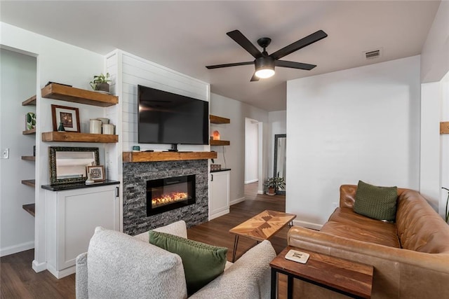 2189 Gordon Cir SE, Smyrna, GA 30080 - living room with a ceiling fan, dark wood-style floors, baseboards, and a stone fireplace