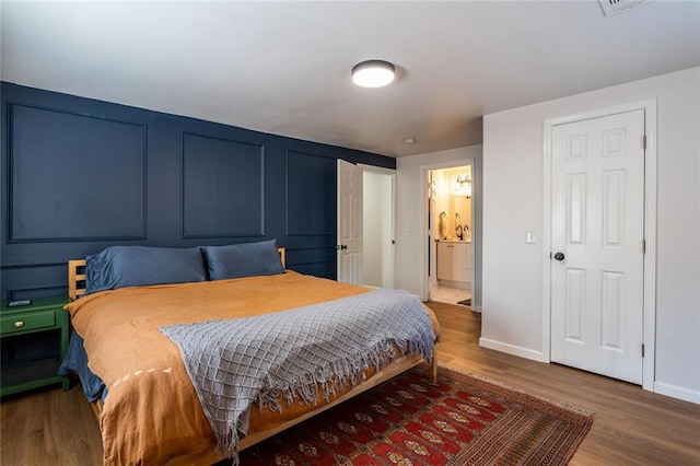 2189 Gordon Cir SE, Smyrna, GA 30080 - bedroom featuring wood finished floors, baseboards, and ensuite bath