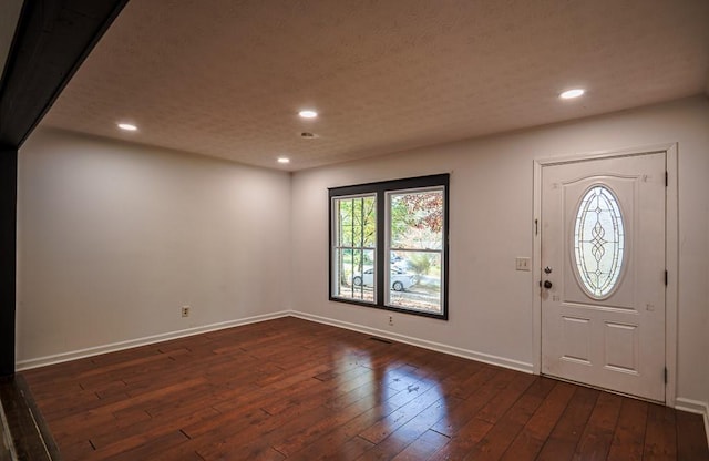 foyer entrance with dark hardwood / wood-style floors