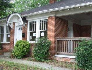 view of home's exterior featuring a chimney and brick siding