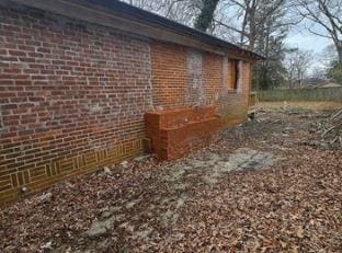 view of side of home with brick siding