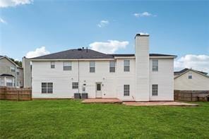 rear view of house with a yard, a patio area, and fence