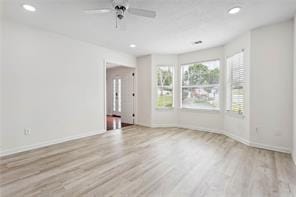 spare room featuring a ceiling fan, recessed lighting, baseboards, and wood finished floors