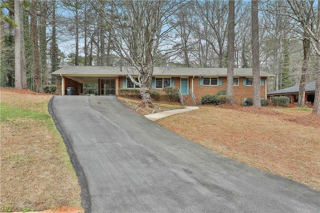 ranch-style home with a front lawn and a carport