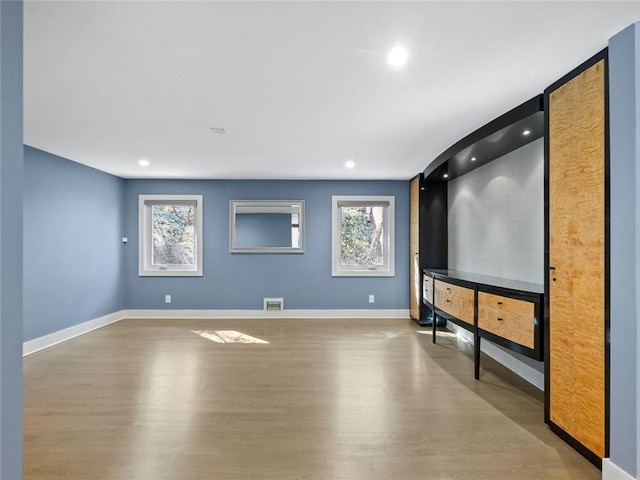 home theater room with recessed lighting, visible vents, baseboards, and wood finished floors