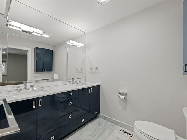 full bathroom featuring toilet, double vanity, visible vents, and a sink